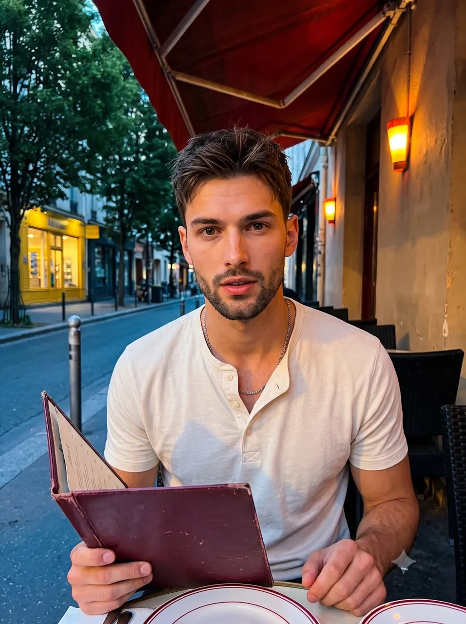 A young handsome male in his late twenties sits centered in a