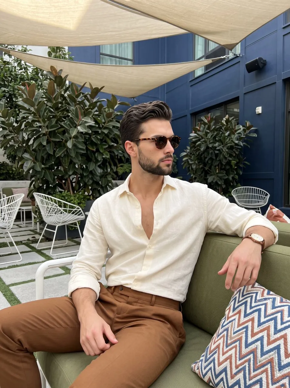 A waist-up portrait captures a young adult male sitting relaxed in