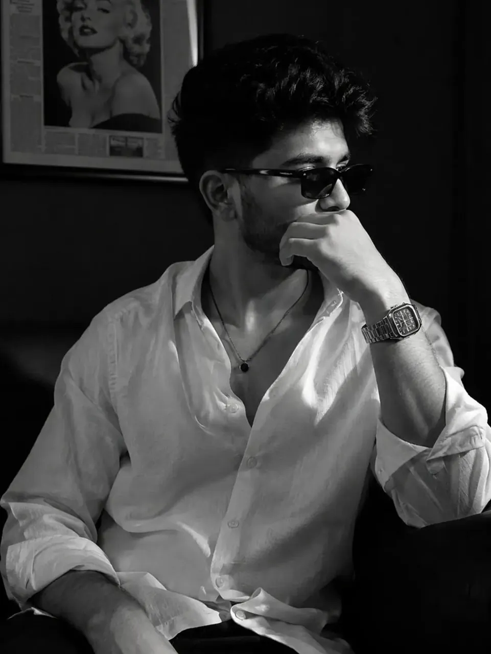 A cinematic black-and-white portrait of a stylish young person