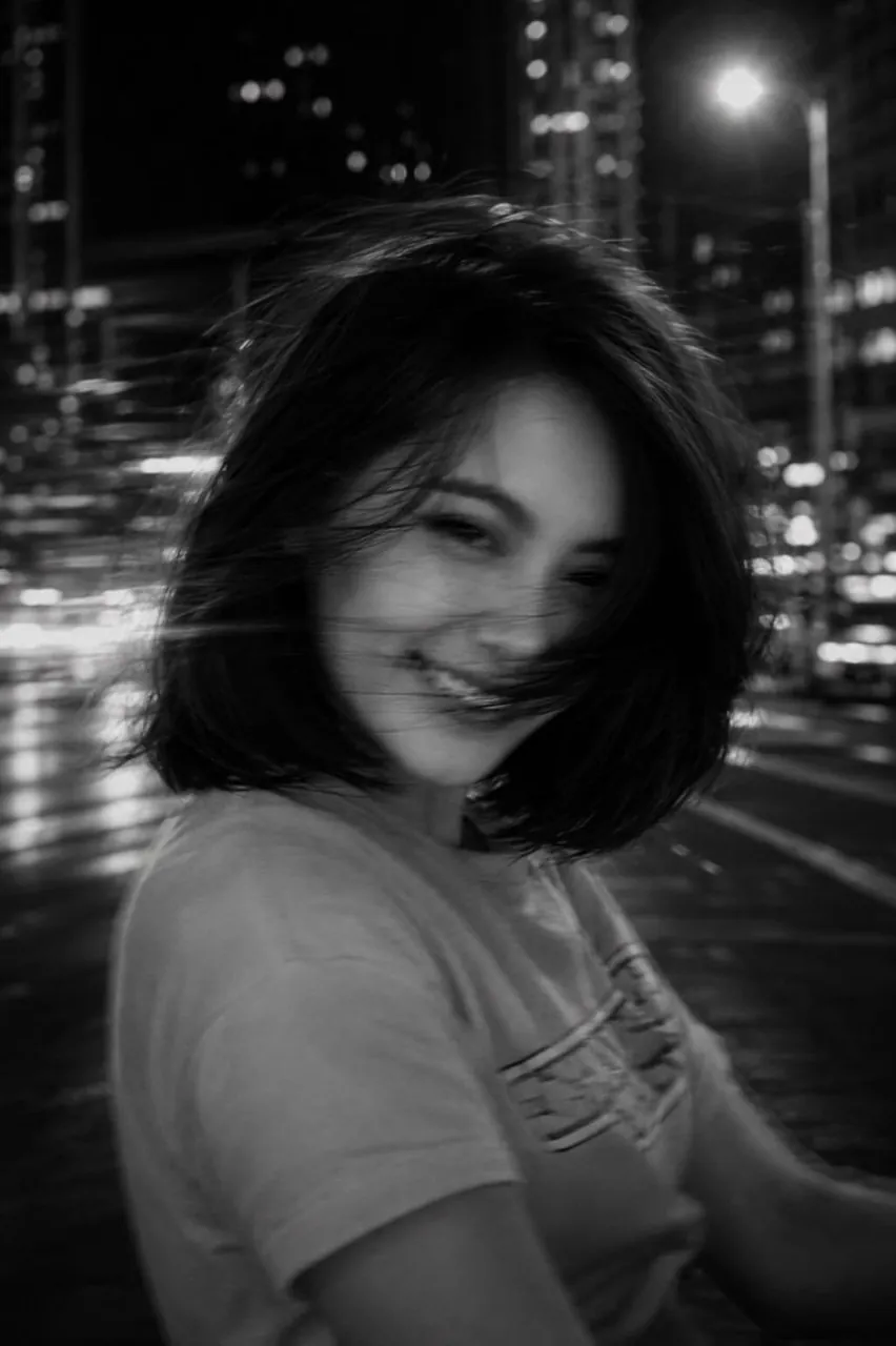 A cinematic black-and-white night street portrait of the uploaded