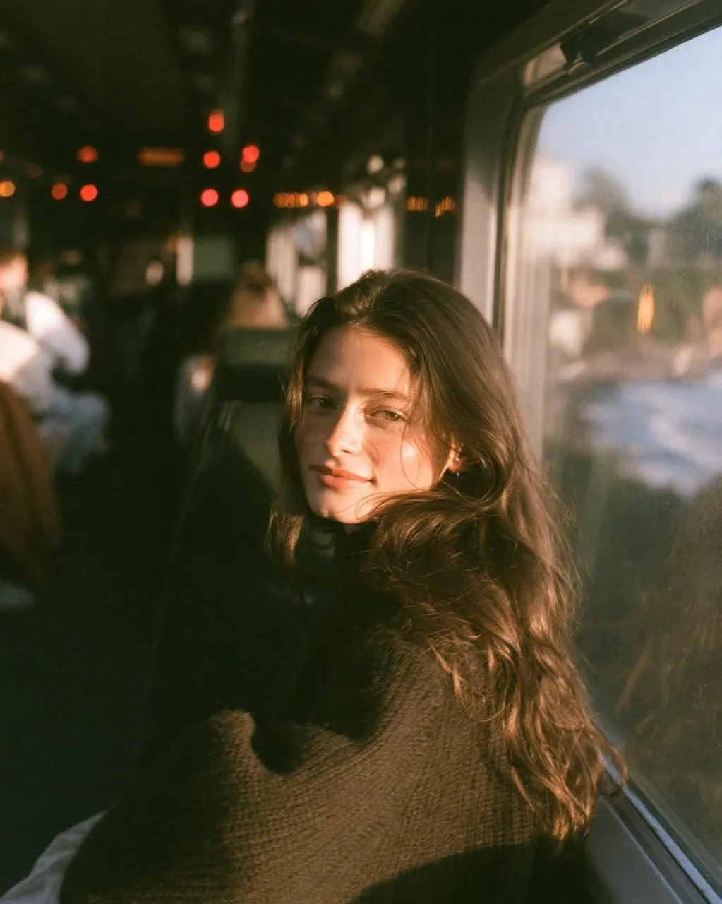 Ultra-cinematic golden hour portrait of a beautiful young woman