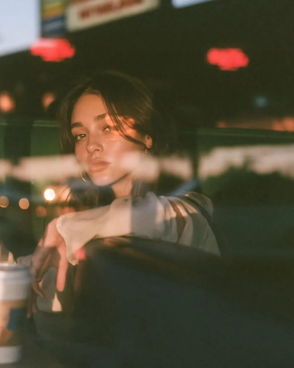 Ultra-cinematic lifestyle portrait photographed through a caf