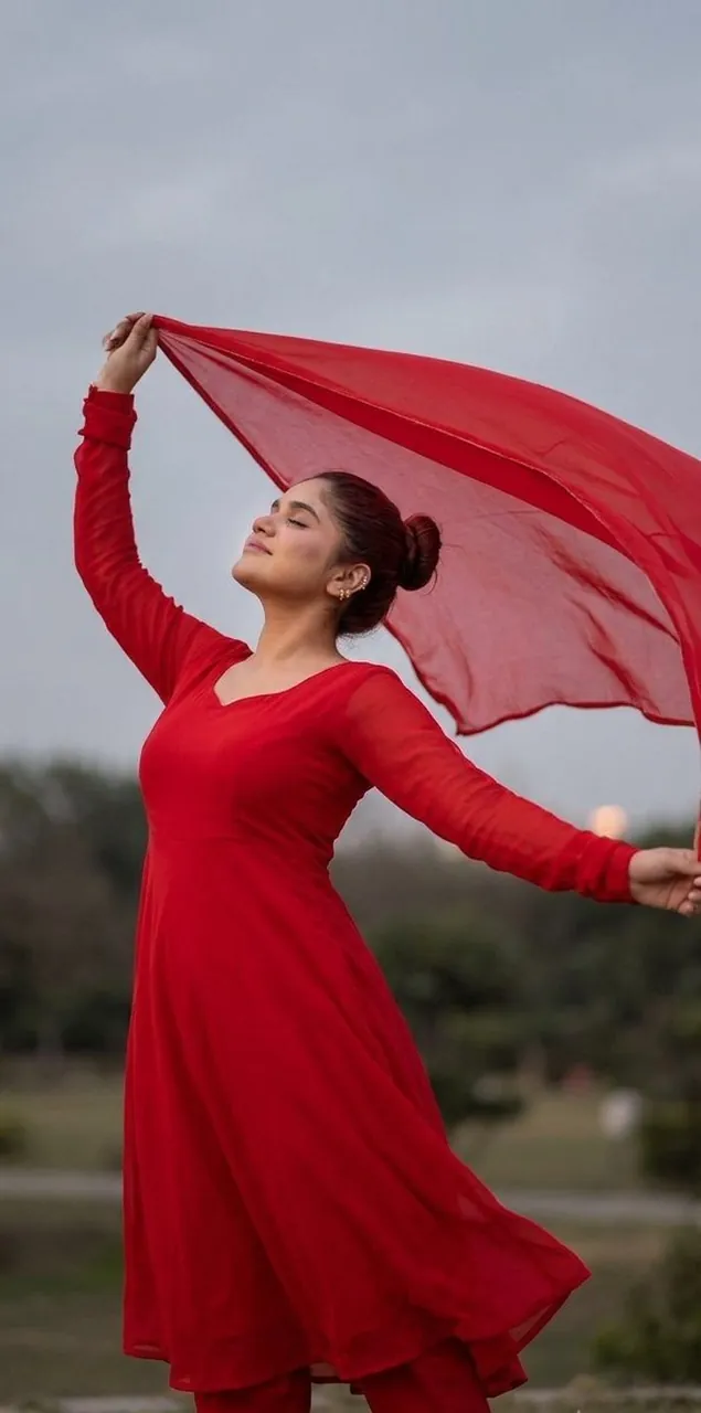 Woman in Red Chiffon Embracing Wind