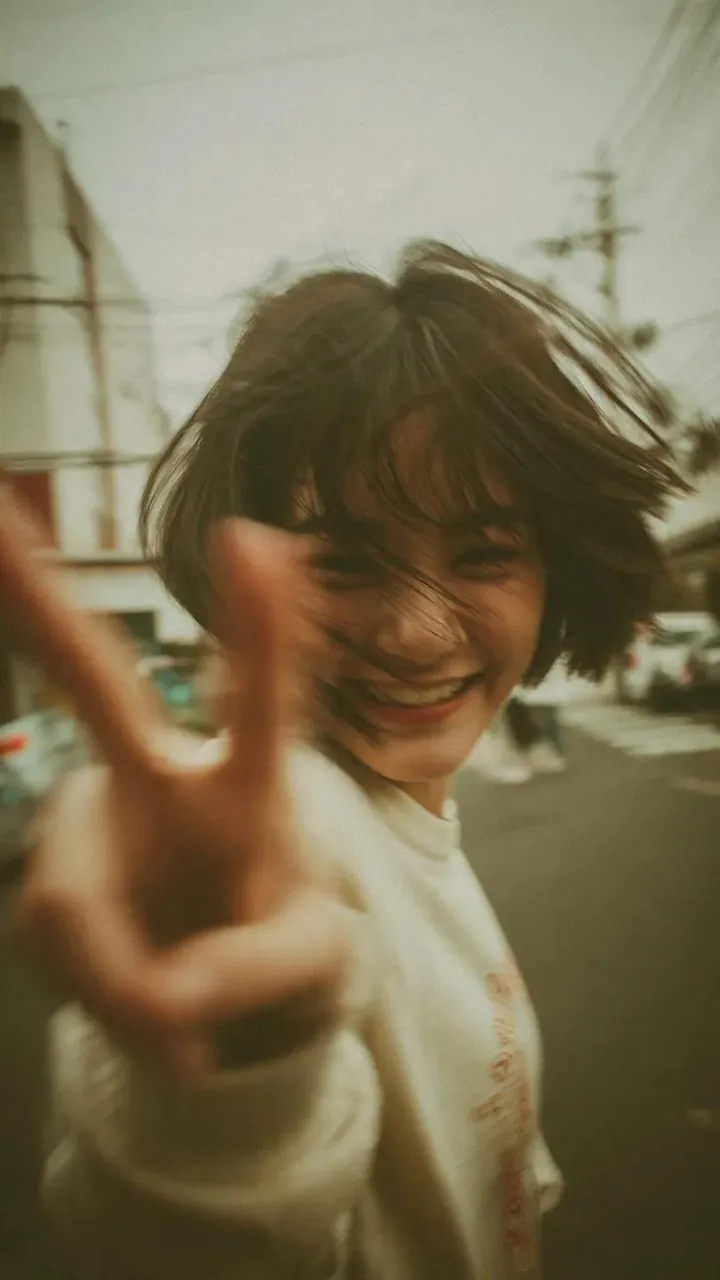 A candid Y2K street photography portrait of a cheerful young woman
