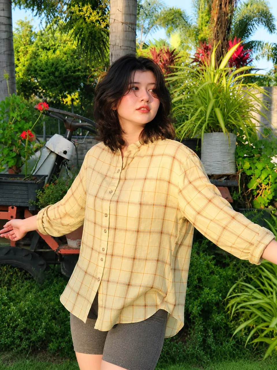 A full-body lifestyle fashion portrait of a young East Asian woman