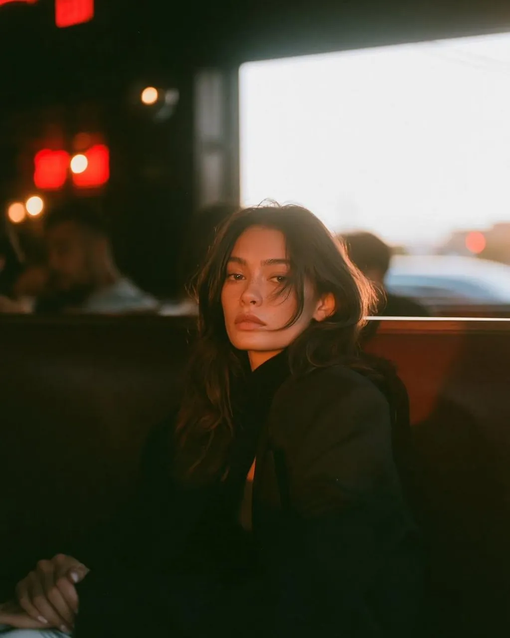 A cinematic caf portrait of a beautiful young woman sitting alone